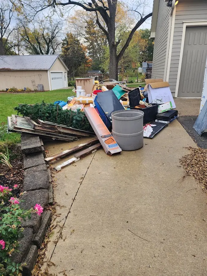 Dumpster being loaded with debris for Estate Cleanout Dumpster Rental in Cypress